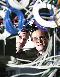 UK professor Hank Dietz, left, and graduate student Tim Mattox have created a supercomputer - KAYS0 - by networking a bank of personal computers.